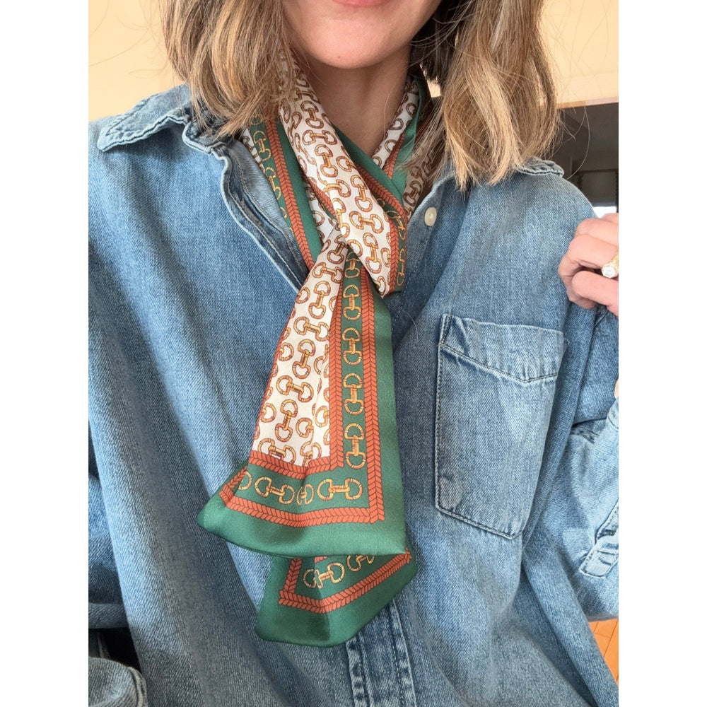 Person wearing a patterned scarf with a denim jacket