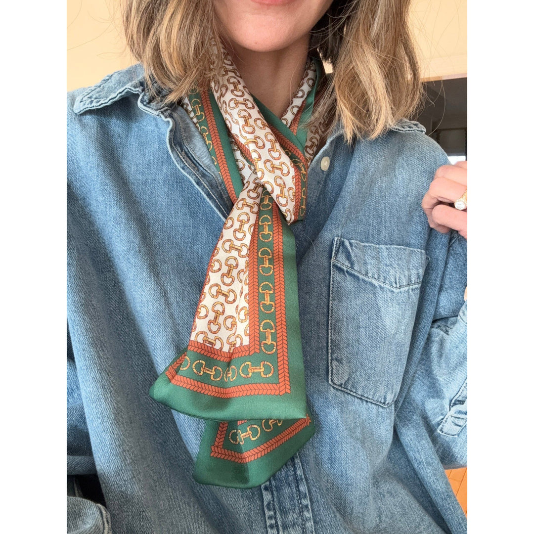 Person wearing a patterned scarf with a denim jacket