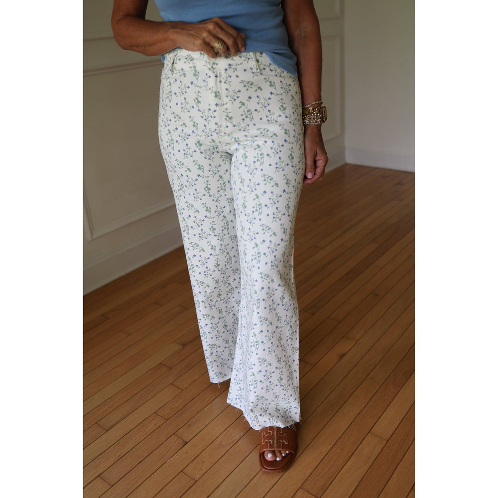 Person wearing white floral pants 