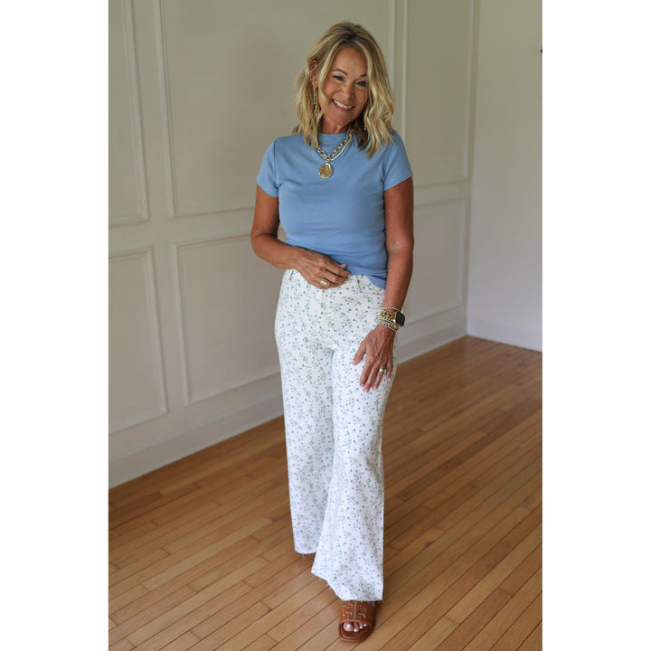 Woman wearing white floral pants 