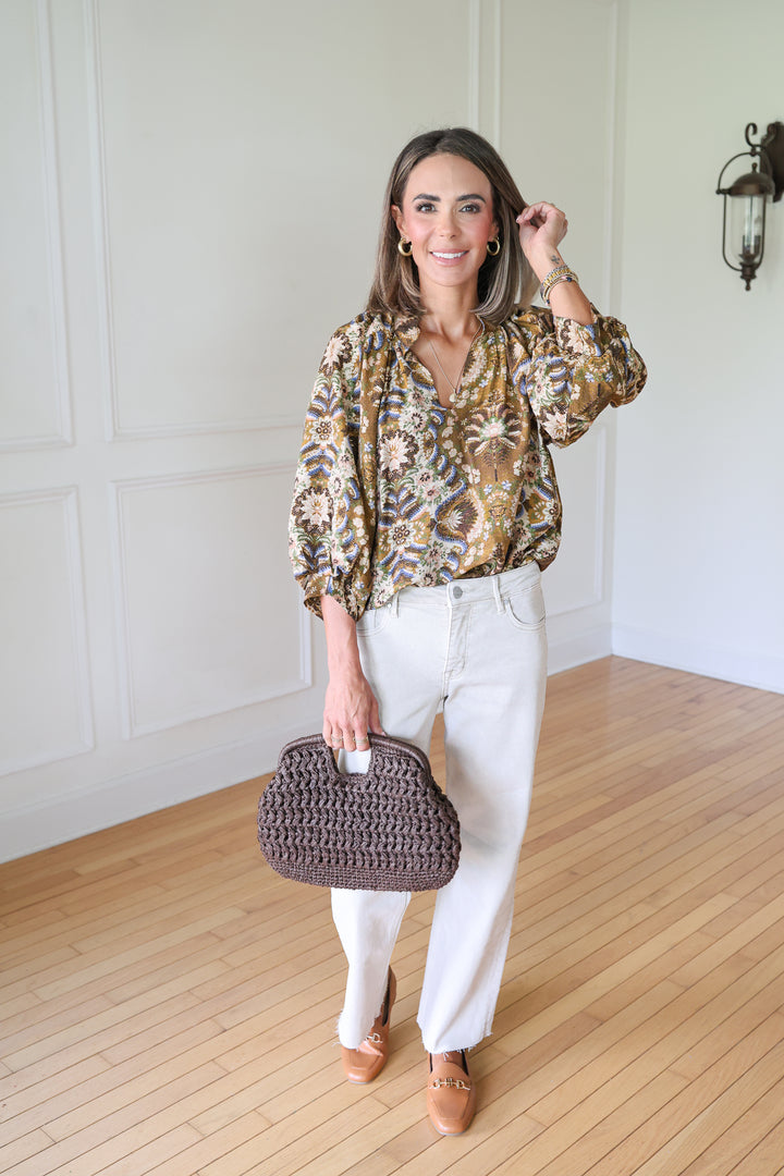 woman wearing tan denim and printed top
