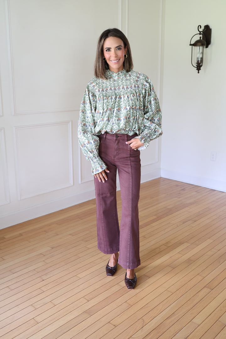 woman wearing brown denim and printed top