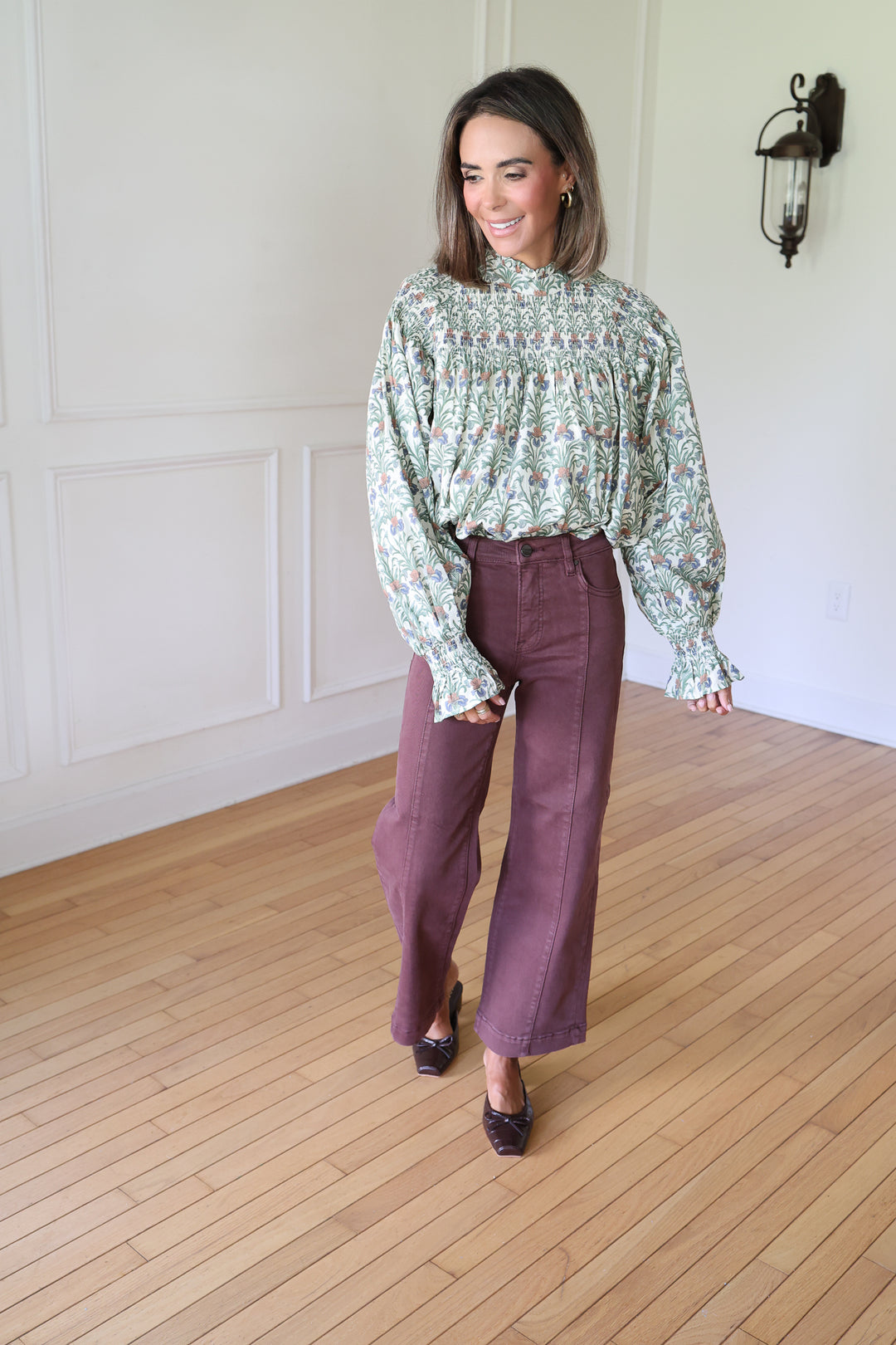 woman wearing brown denim and a floral top