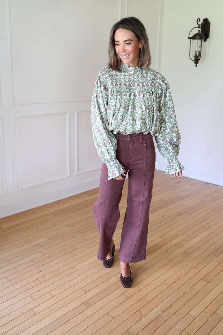 woman wearing brown denim and a floral top