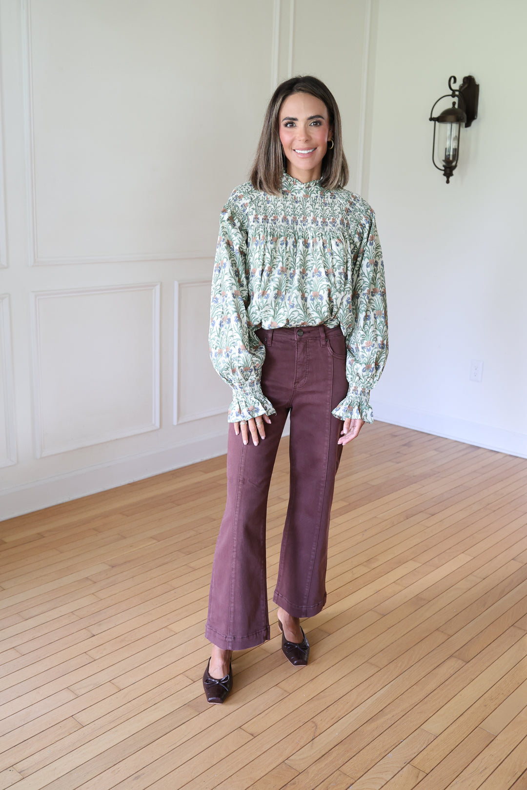 woman wearing brown denim and printed top