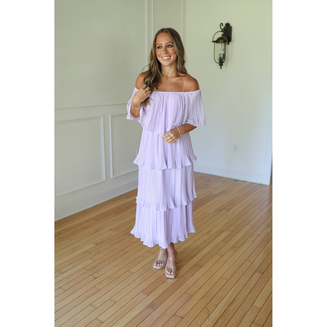 Woman wearing a light purple off-shoulder dress 