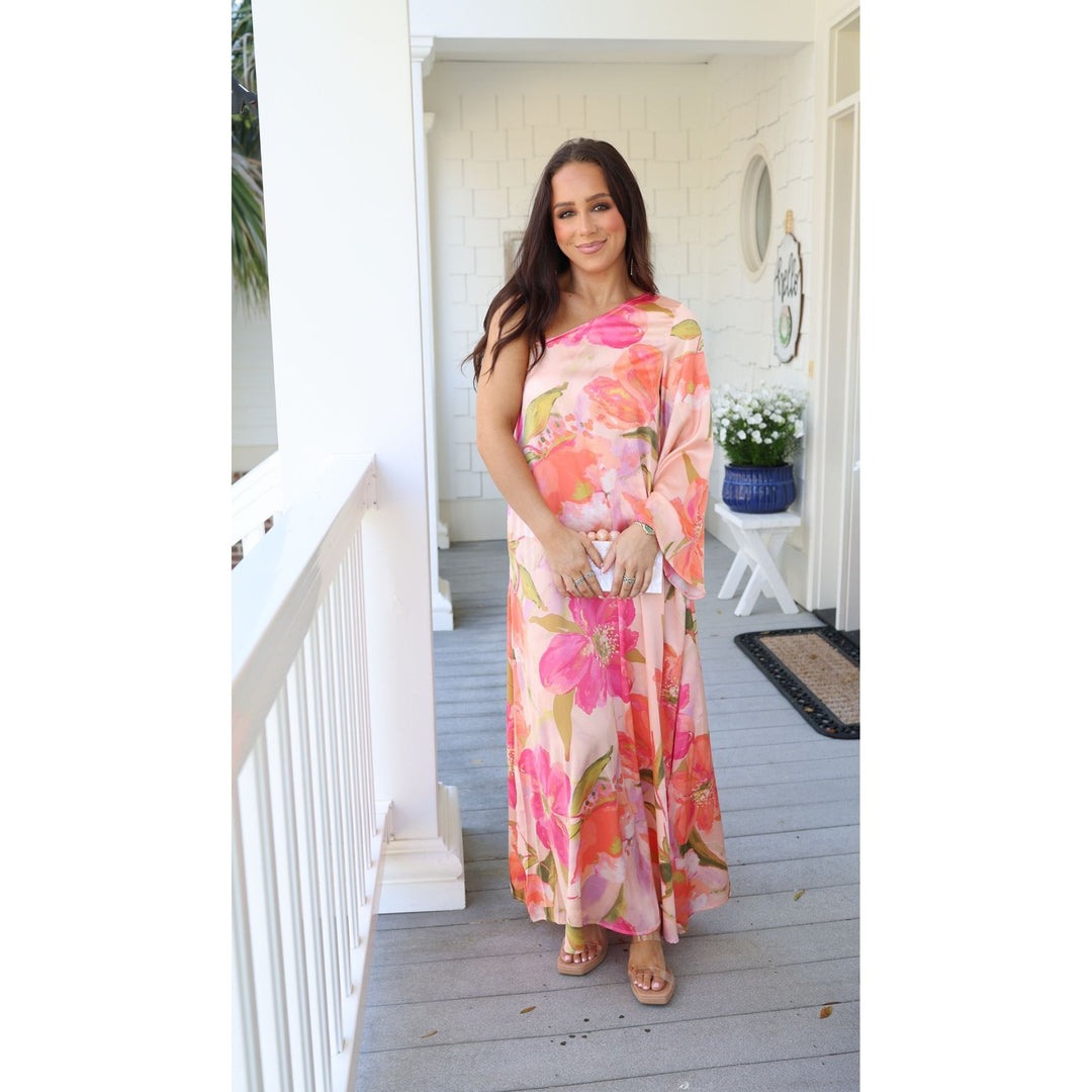 Woman in a floral dress standing on a porch