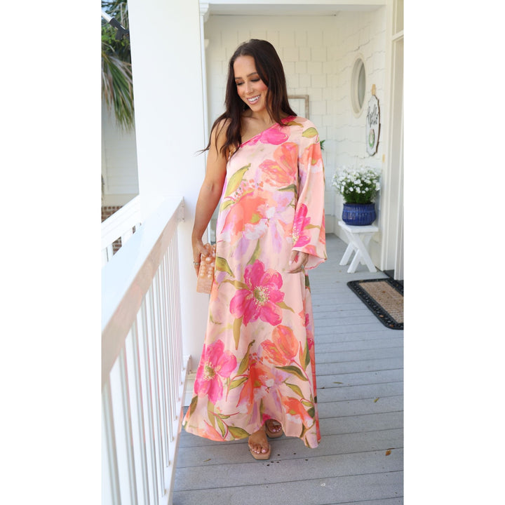 Woman in a floral dress standing on a porch