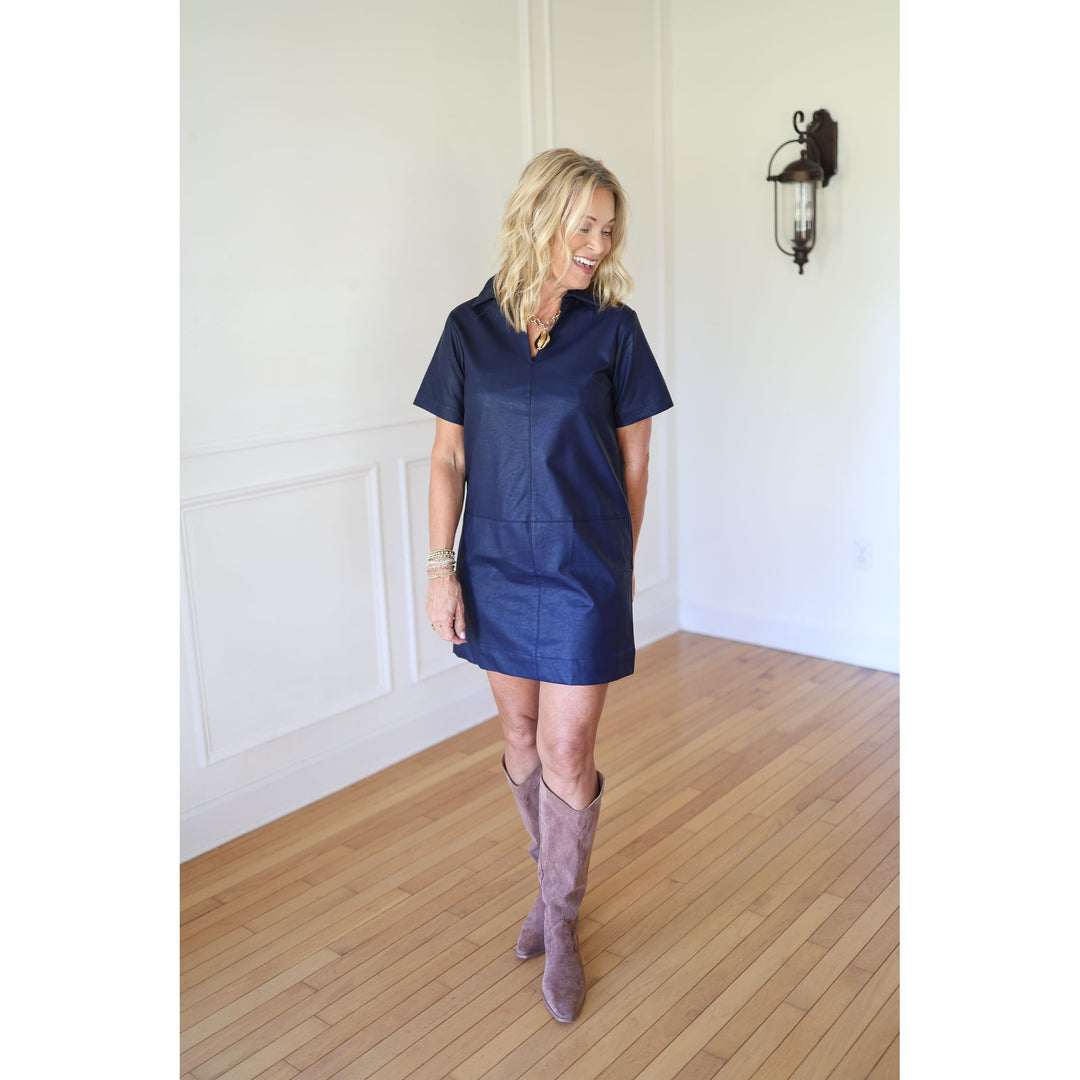 Woman wearing a navy dress and boots 