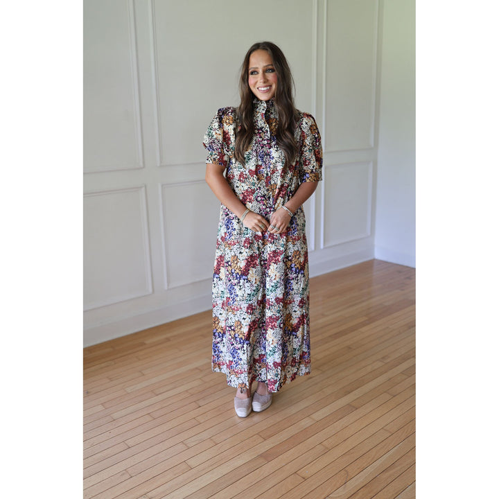Woman in a floral dress standing 
