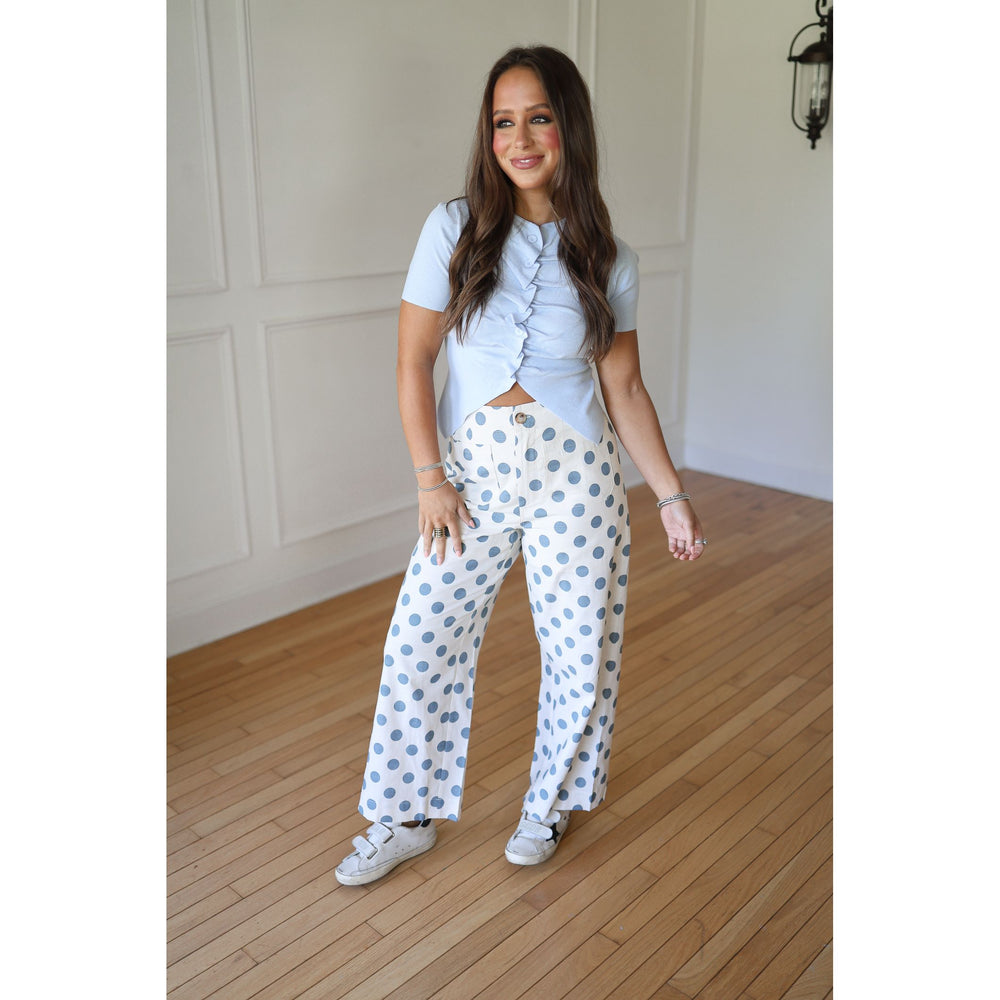 Woman wearing a light blue top and polka dot pants 