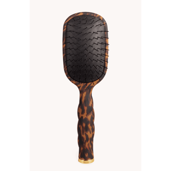 Hairbrush with tortoiseshell handle on a white background