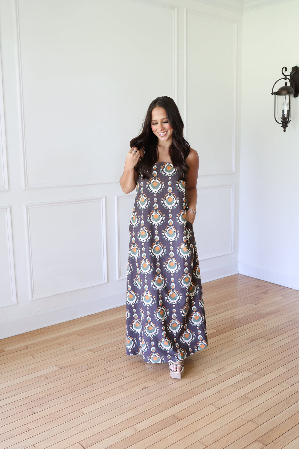 woman wearing brown print maxi dress
