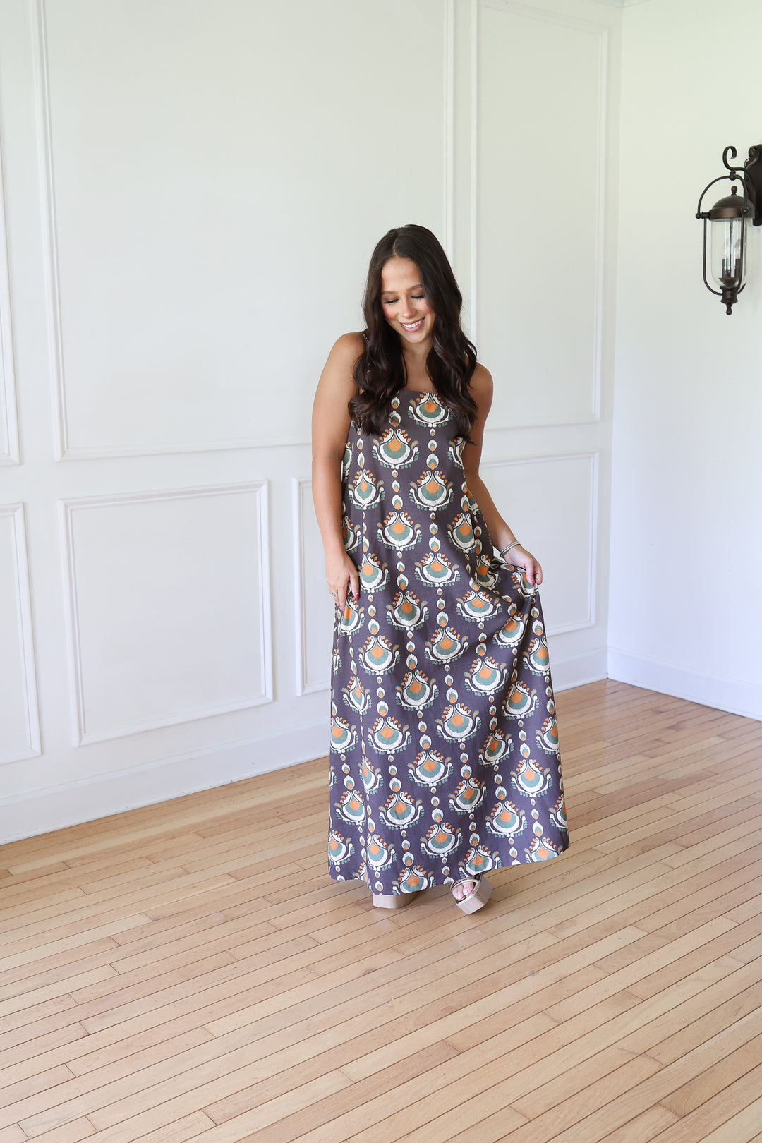 woman wearing brown print maxi dress