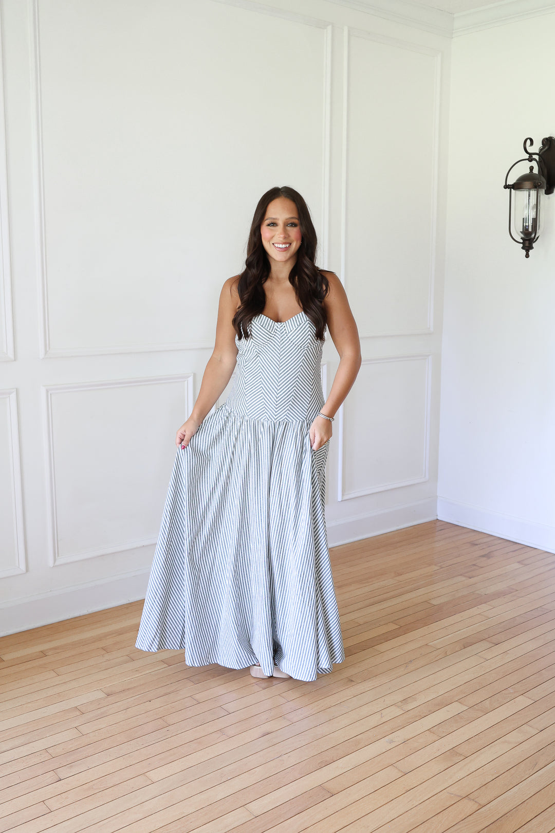 woman wearing green striped maxi dress