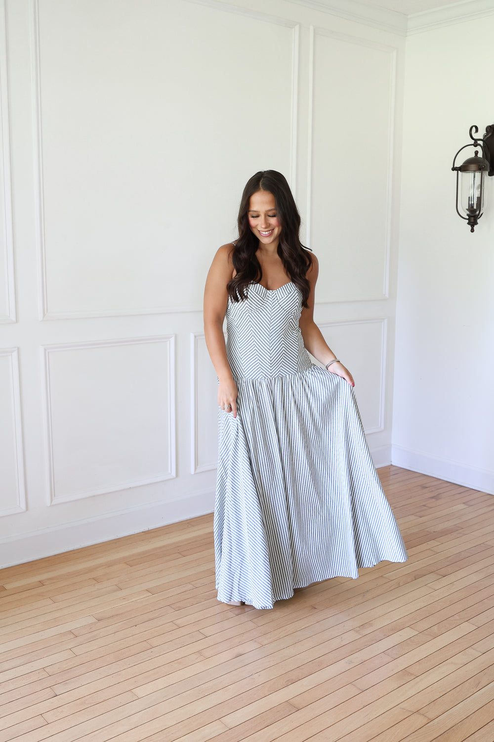 woman wearing green striped maxi dress