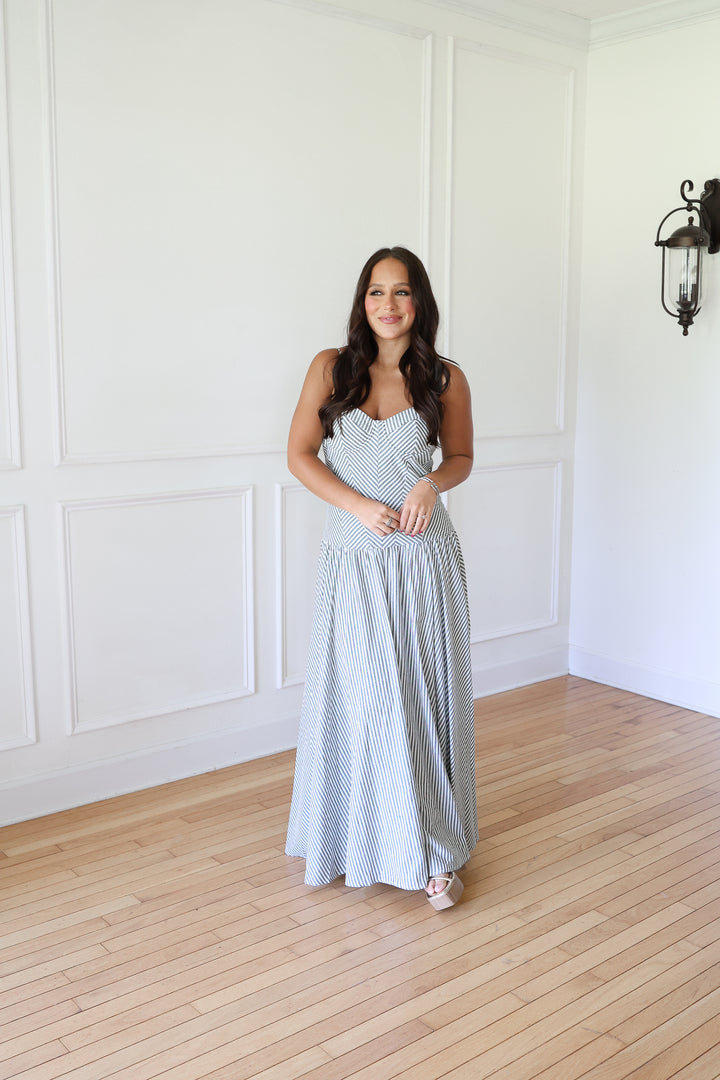 woman wearing green striped maxi dress