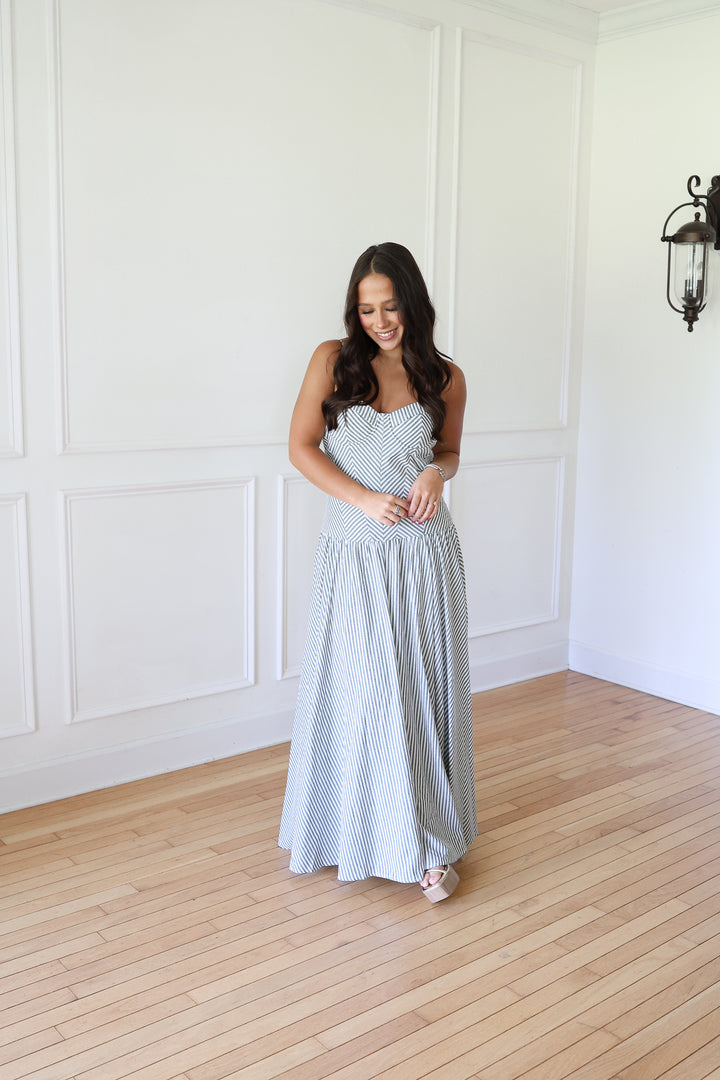 woman wearing green striped maxi dress