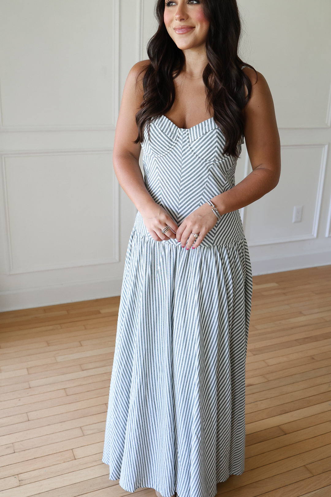 woman wearing green striped maxi dress