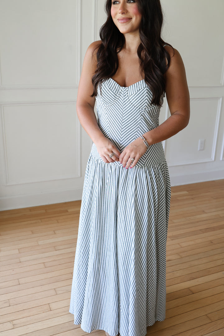 woman wearing green striped maxi dress