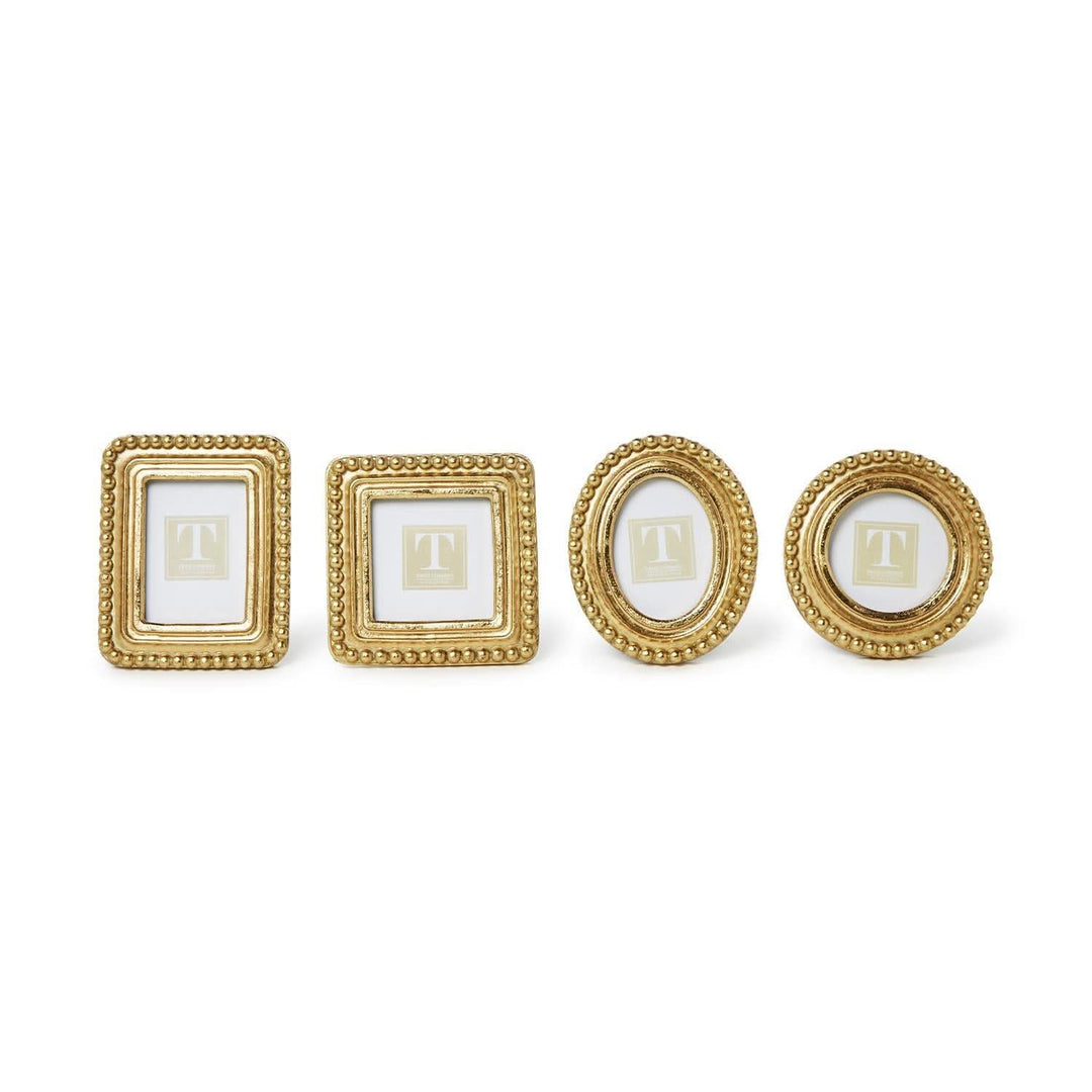 Set of four gold picture frames on a white background