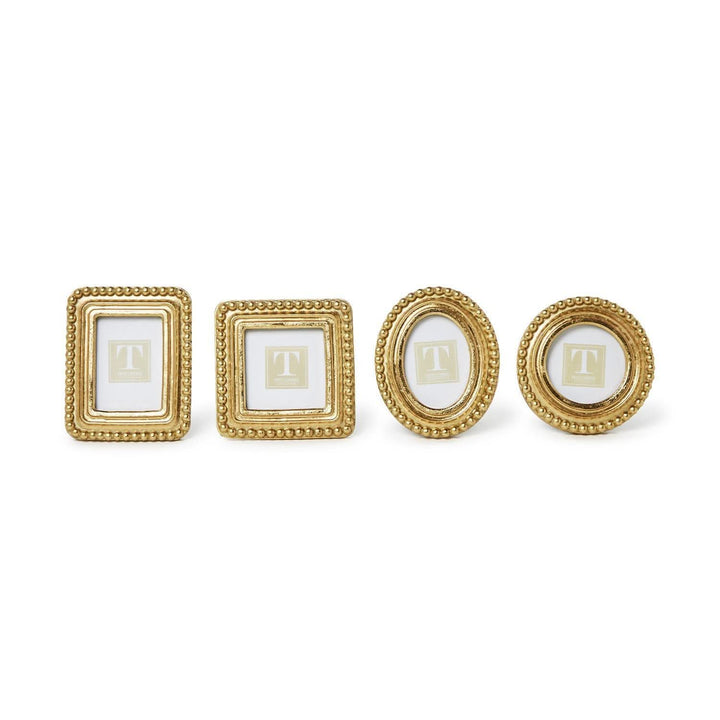 Set of four gold picture frames on a white background