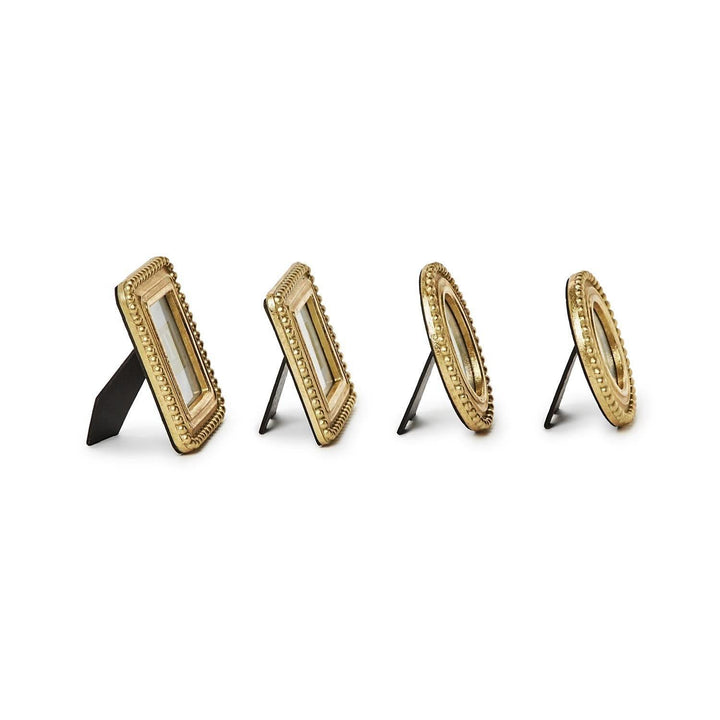 Set of four gold picture frames on a white background