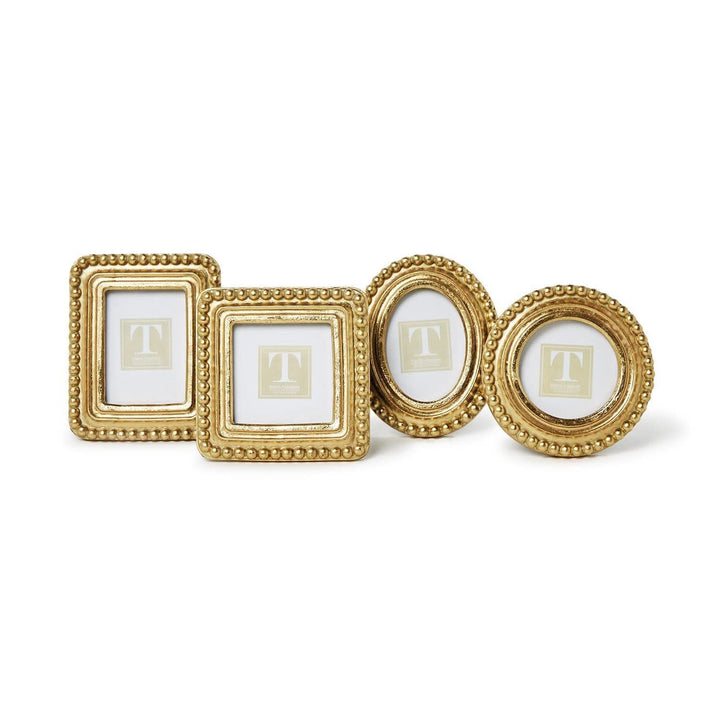 Set of four gold picture frames on a white background