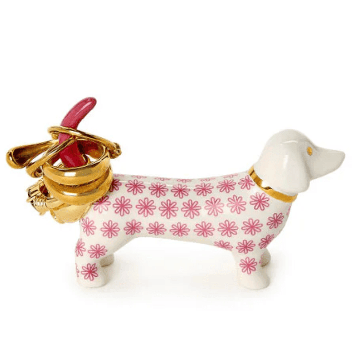 Dog-shaped ring holder with floral pattern and gold accents on a white background
