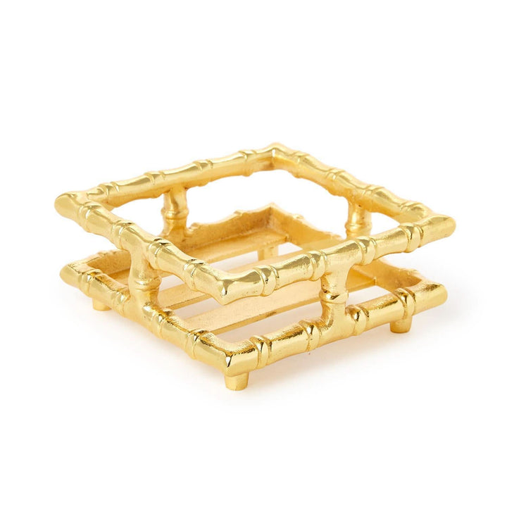 Set of gold coasters with bamboo design on a white background
