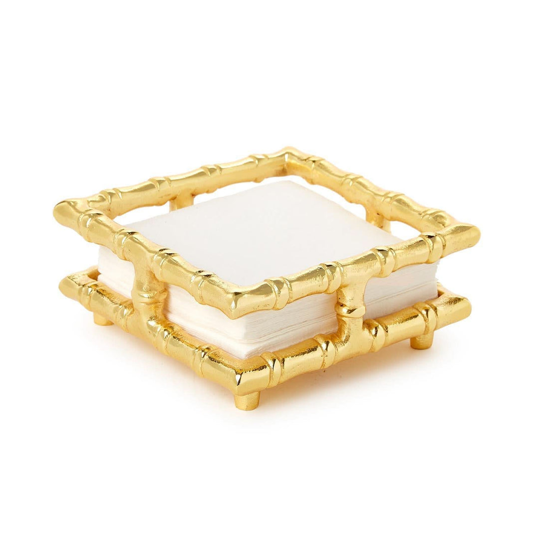 Gold bamboo-style soap dish with white soap on a white background