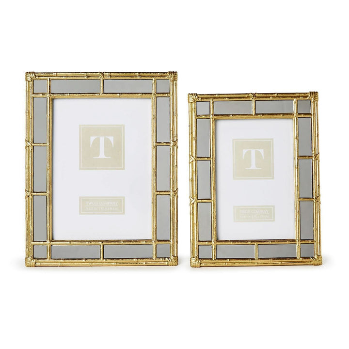 Two decorative picture frames with gold and glass design on a white background