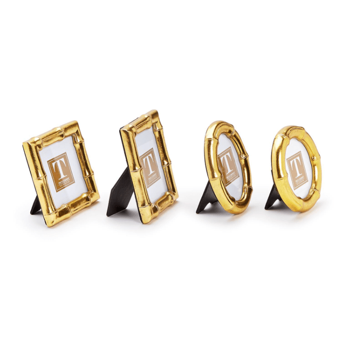 Four gold photo frames with white backgrounds on a white background