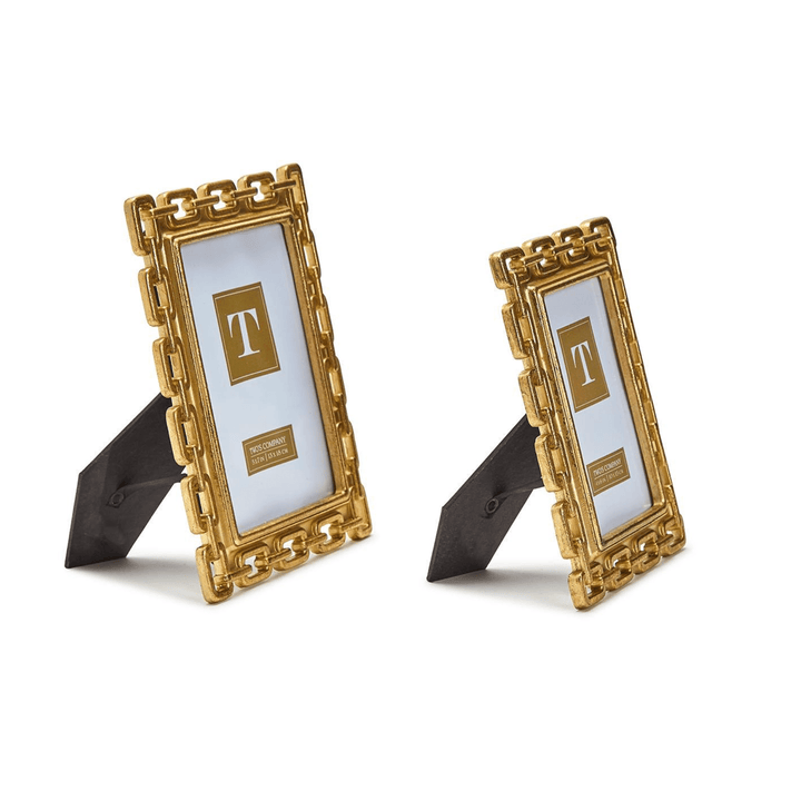 Two gold photo frames with decorative designs 