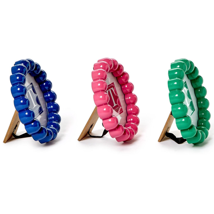 Three colorful beaded bracelets on stands 