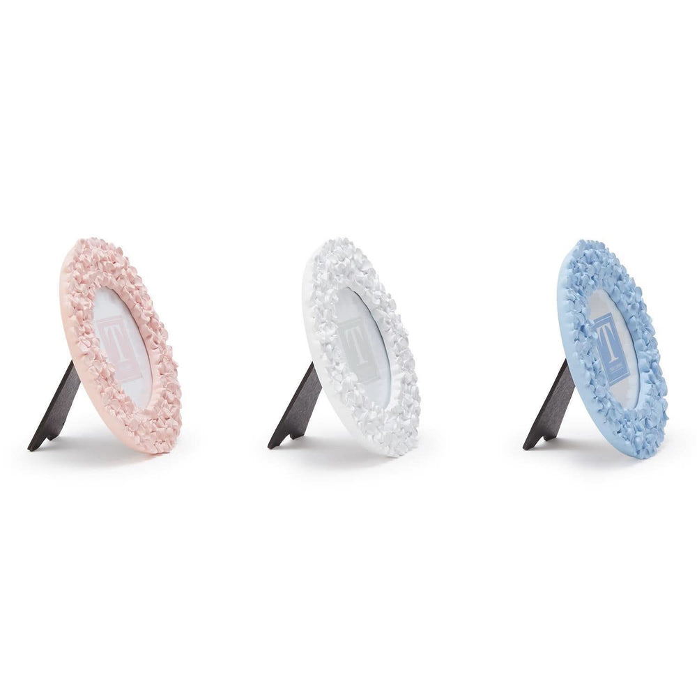 Three circular cleaning pads with textured edges on stands against a white background