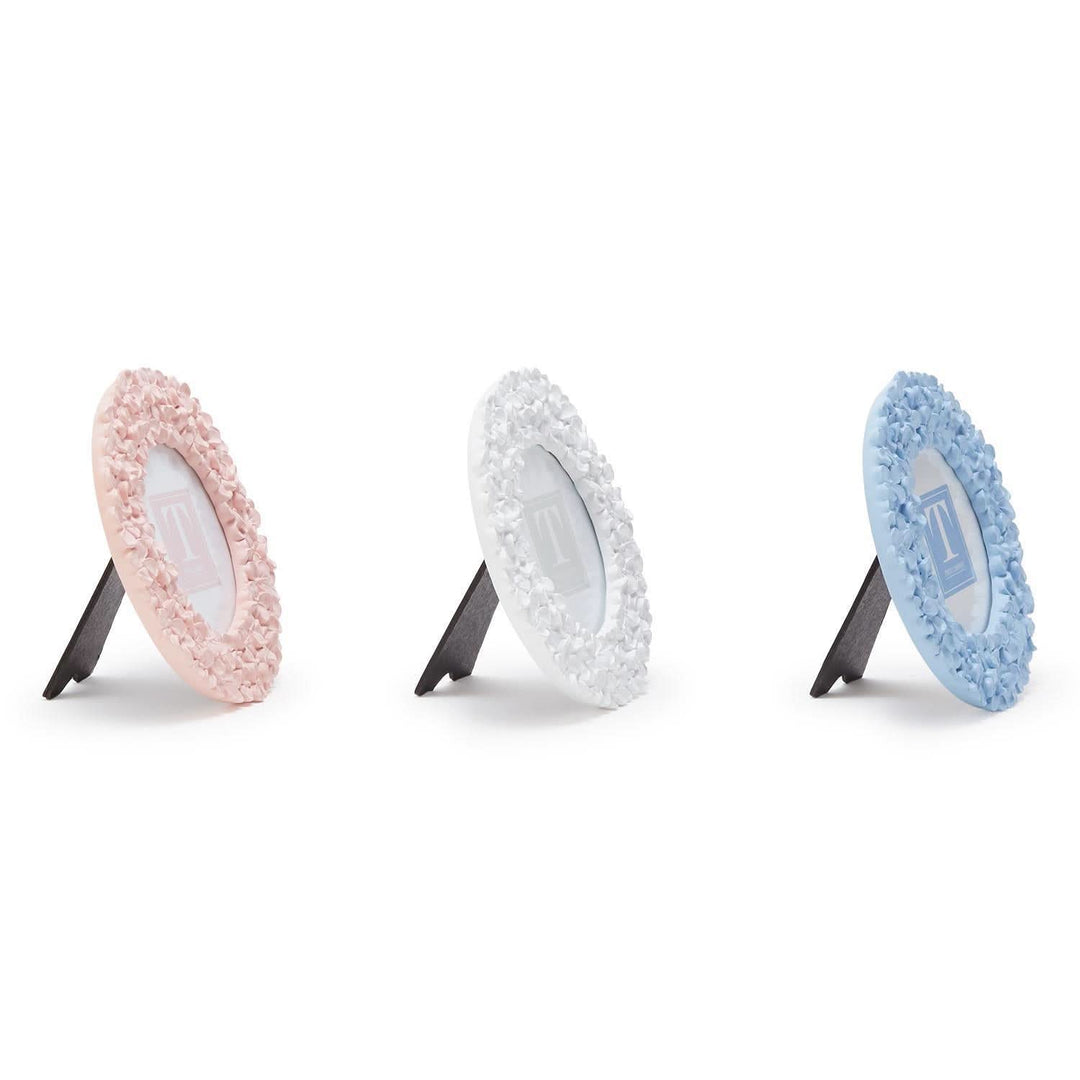 Three circular cleaning pads with textured edges on stands against a white background