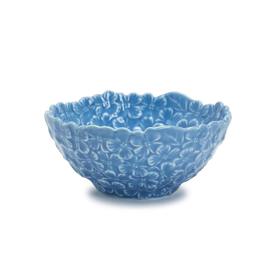 Blue ceramic bowl with floral patterns on a white background