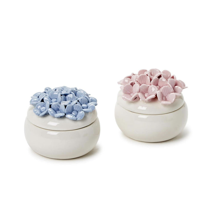 Two ceramic containers with floral designs on a white background