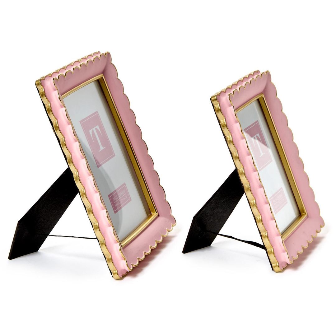 Two pink and gold picture frames on stands 