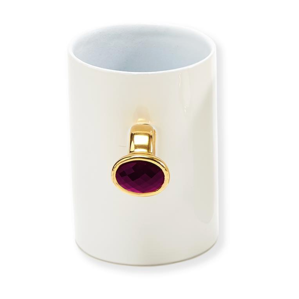 White mug with a gold and pink gemstone o