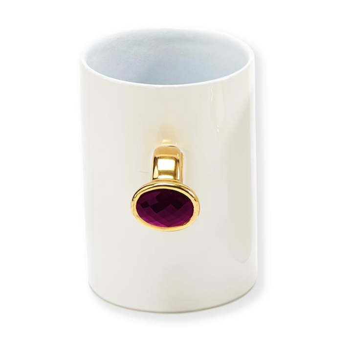 White mug with a gold and pink gemstone o
