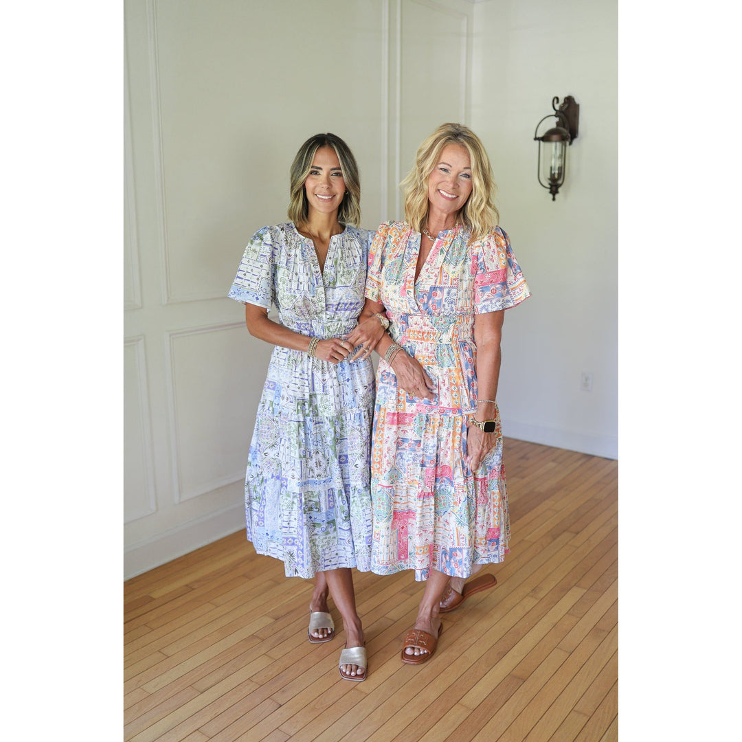 Two women wearing patterned dresses 