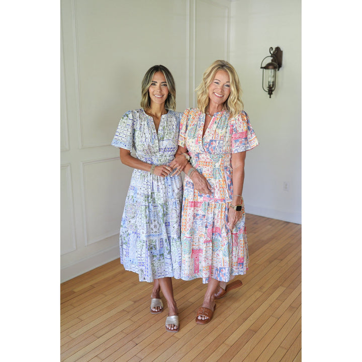 Two women wearing patterned dresses 