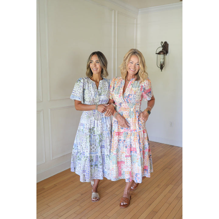 Two women wearing patterned dresses 