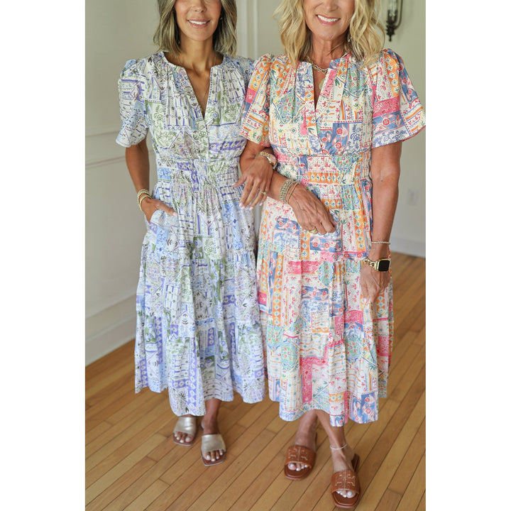 Two women wearing colorful patterned dresses 