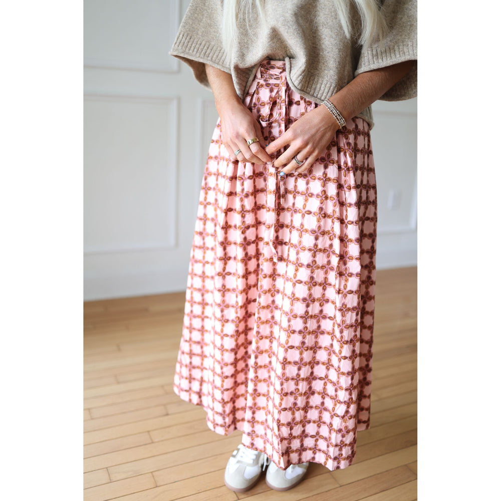 Person wearing  pink checkered skirt 